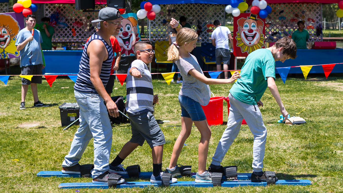 Guests at a James Event Productions Picnic having fun in a family game.