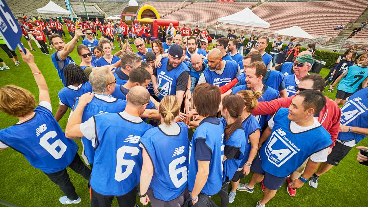 A team of employees gather to give a cheer as their team building event hosted by James Event Productions begins.