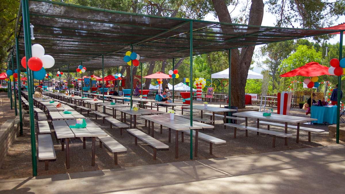 Ample shaded seating at the top of Lakeview Park in Orange , CA overlooks Irvine Lake and beautiful lawns shaded by old growth live oak trees.