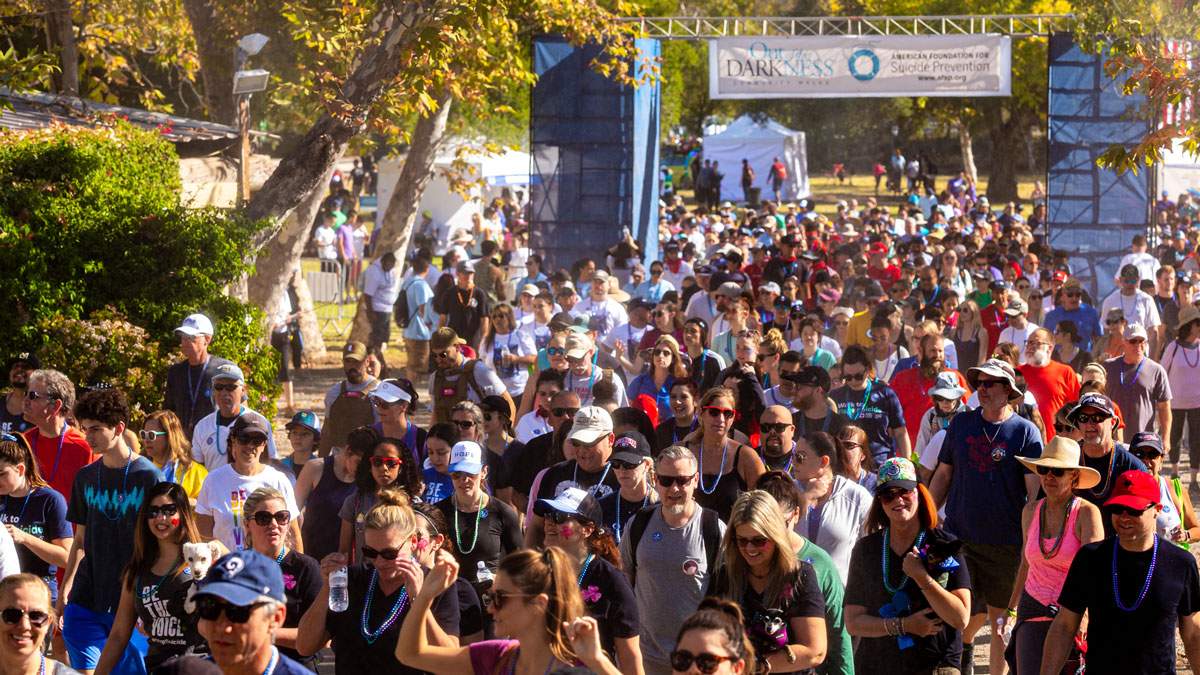 Thousands of participants at the starting line for an annual walk to raise funds for a non-profit organization.