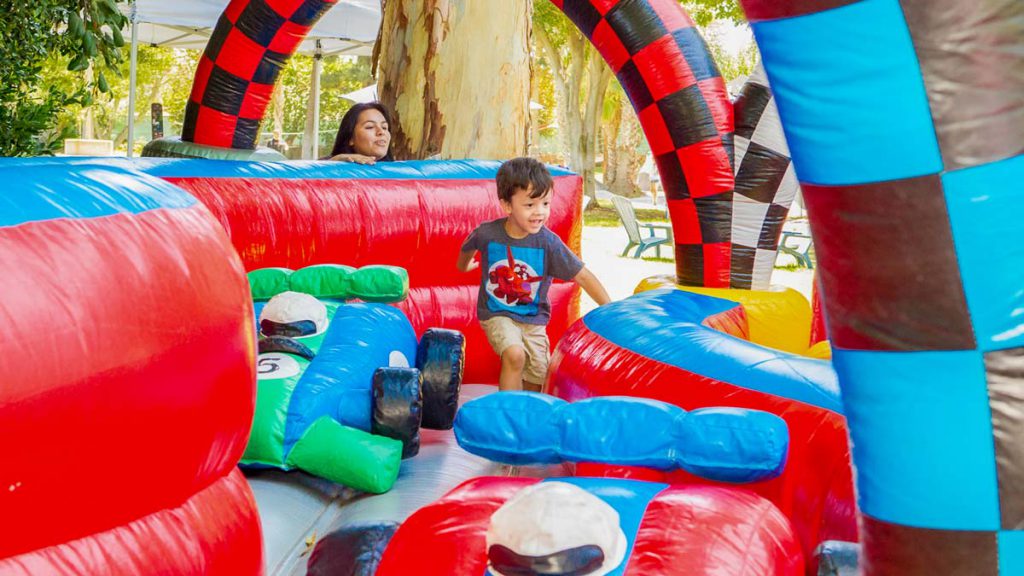 This colorful Raceway Inflatable Track will keep your tiny racers entertained as they navigate a course filled with obsatcles and curves.