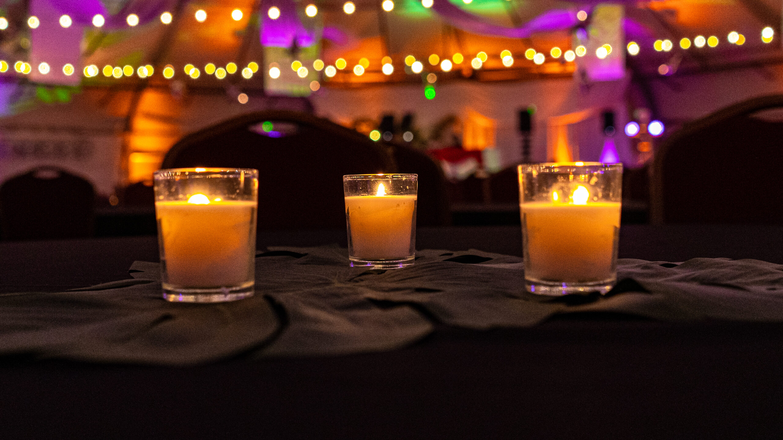 Beautiful candles on a table at a James Event Productions party.