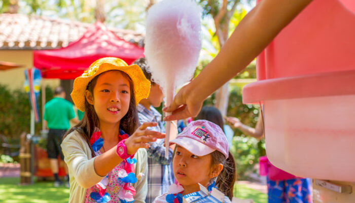 Two young girls ready to enjoy some freshly made cotton candy at a James Event Productions picnic.